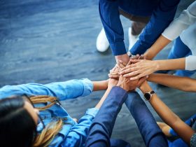 A diverse group of hands stacked on top of each other.