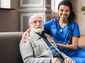 A female nurse with her arm around an elderly male patient.