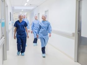 Nurses walk down a hallway